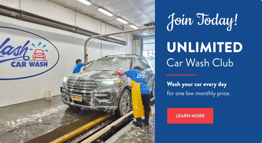Two workers hand-washing a soapy SUV at a Splash Car Wash